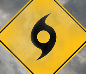 Yellow street sign with a hurricane symbol