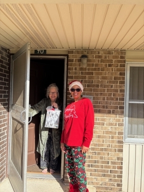 Angela Workman outside with resident holding the screen door.