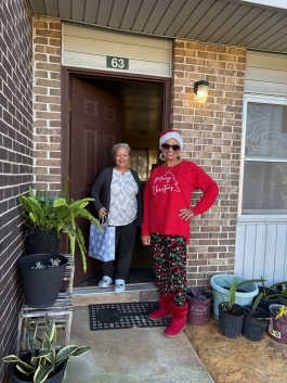 Angela Workman with resident in her doorway.